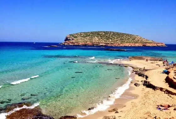 Platge De Compte Ibiza beach with holiday makers