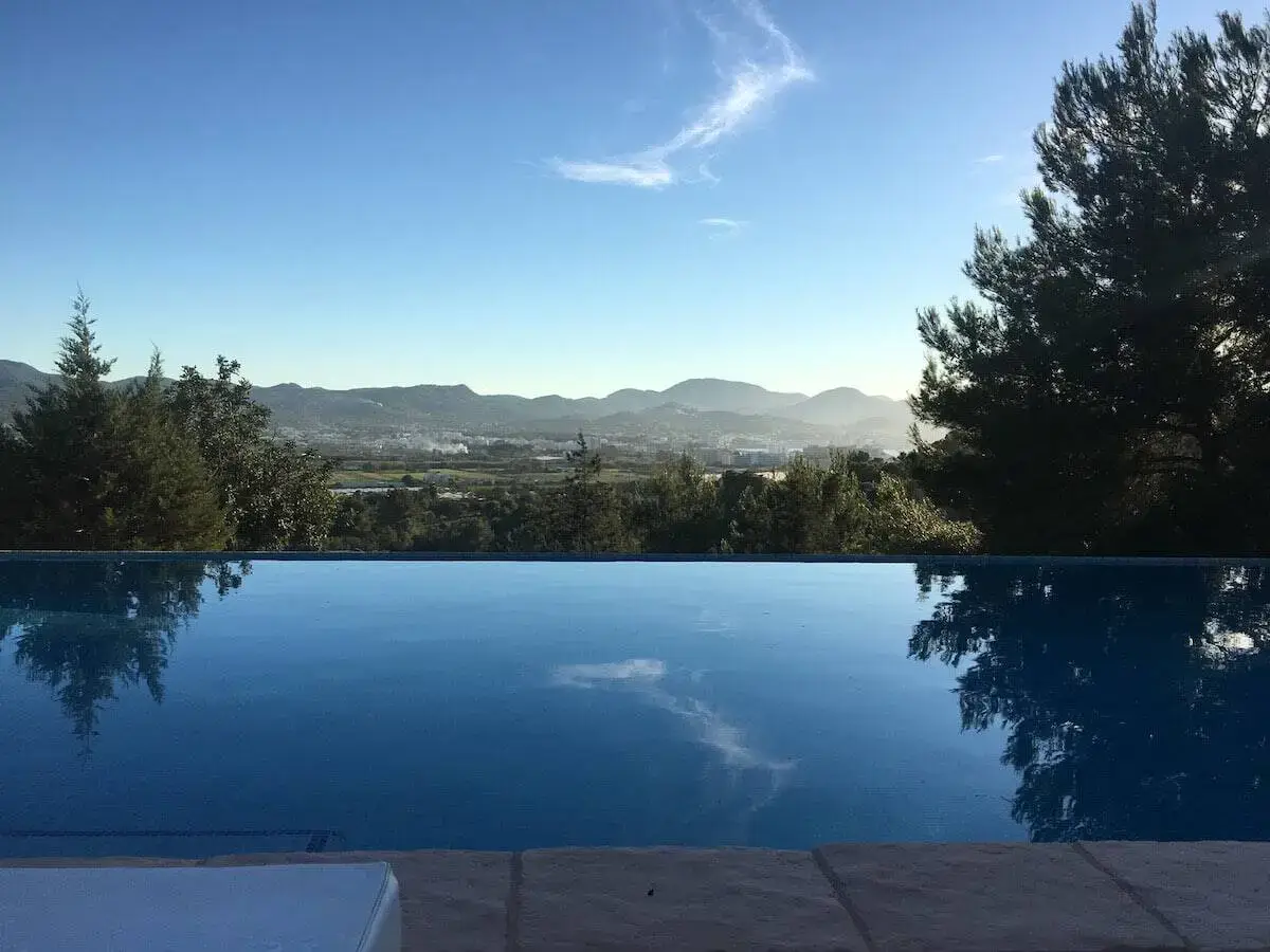 Can Frare Ibiza infinity pool in winter against backdrop of hills in the distance