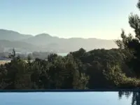 Can Frare Ibiza winter view of infinity swimming pool and hills in the distance