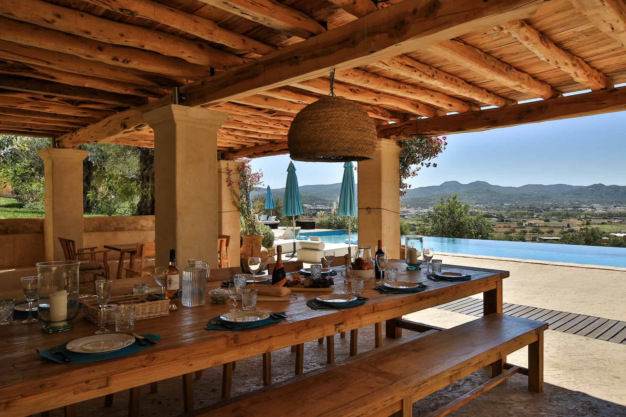 Can frare outdoor dining overlooking the swimming pools, dinner table set for casual lunch