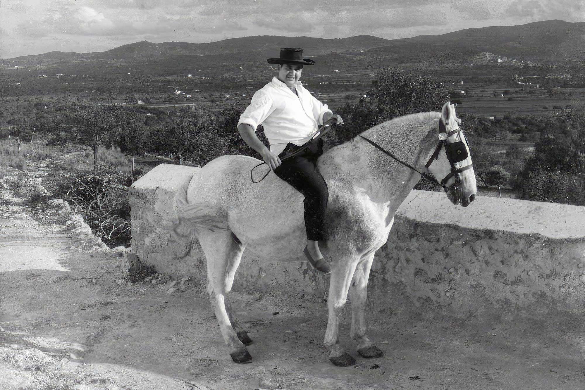The History of Can Frare Ibiza Image with man in hat and white shirt on white horse